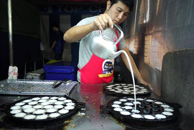 man making coconut pancakes
